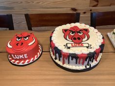 three cakes decorated to look like pigs with the words luke on them and one is red