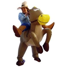 a man riding on the back of an inflatable horse wearing a cowboy hat