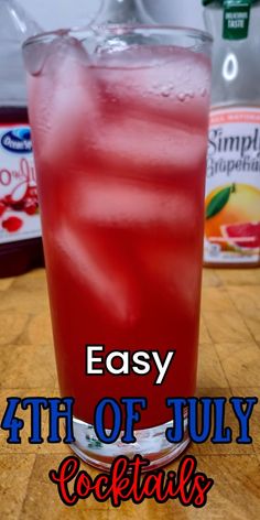 a red drink sitting on top of a wooden table