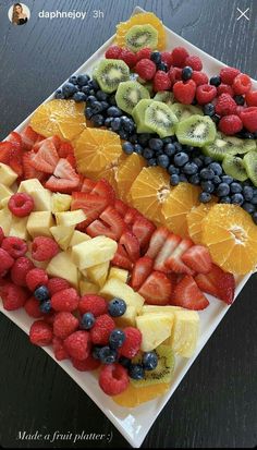 a platter filled with sliced fruit on top of a wooden table