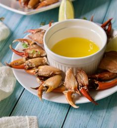 crab legs with dipping sauce on a plate