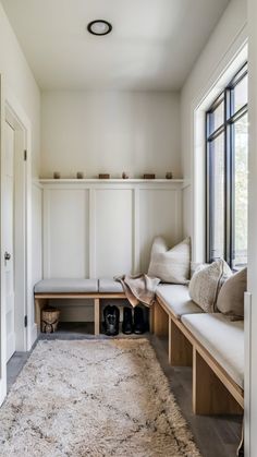 a room with white walls and wooden benches