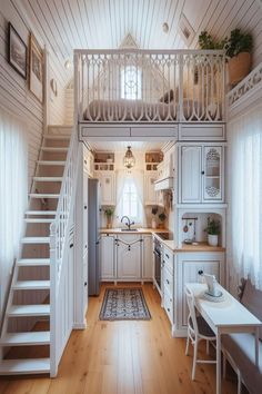 a kitchen with white cabinets and stairs leading to the upper floor, next to a dining room table