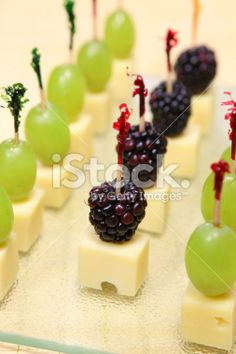 grapes and cheese are arranged on skewers with toothpicks in the form of fruit