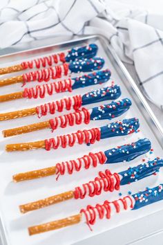 red, white and blue pretzels are arranged in rows on a baking sheet