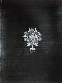 an old black book with white designs on it