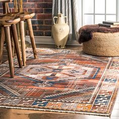 an area rug is shown in front of a brick wall and wooden chair with a basket on the floor