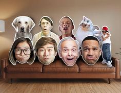 a group of people sitting on top of a couch with their faces cut out to look like dogs and cats