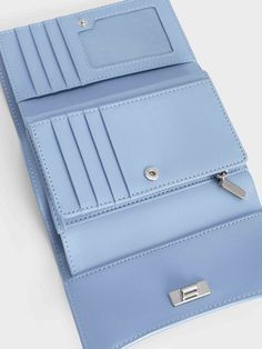 Add a sophisticated touch to your everyday looks with this light blue iteration of our Huxley front flap wallet. Featuring a sleek curved front flap and knotted silver-toned metallic accent, this charming piece will elevate your style game in an instant. Opening up to reveal multiple compartments that will keep your cards, cash and other small items neat and organised, this sweet accessory is the epitome of functional style. Sweet Accessories, Functional Style, Charles Keith, Metallic Accents, Card Wallet, Everyday Look, Patch Pocket, Latest Fashion, Silver Tone