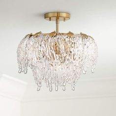 a chandelier hanging from the ceiling in a room with white walls and flooring