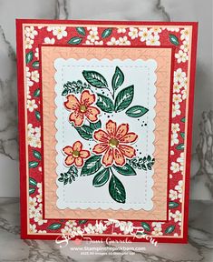 a close up of a card with flowers and leaves on the front, in red and white