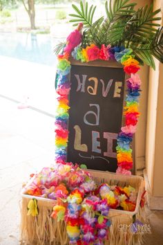 there is a sign that says have a lei and some flowers in front of it