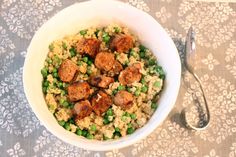 a bowl filled with peas and meat on top of a table