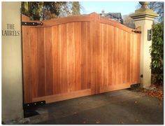 a large wooden gate in front of a house