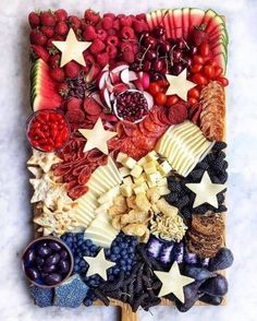 a platter filled with fruits and vegetables on top of a table