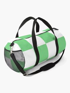 a multicolored duffel bag sitting on top of a white surface