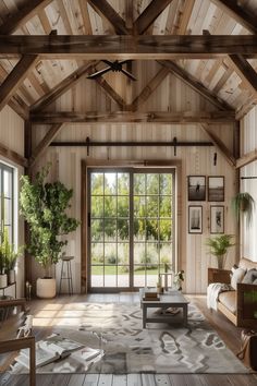 a living room filled with furniture and lots of wooden walls covered in windows next to a door