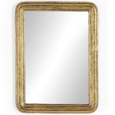 a gold framed mirror on a white wall