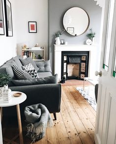 a living room filled with furniture and a fire place