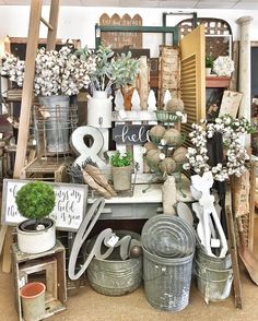 a room filled with lots of different types of pots and plants on top of each other