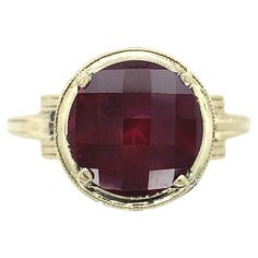 14K yellow gold ring with white gold filigree set with a large round rhodolite garnet. The garnet weighs 4 1/2 carats and measures about 10mm. The garnet has raspberry darker pink color with a specialty checkerboard top. The ring fits a size 8.5 finger and weighs 2.5dwt. It dates from the 1950-60's. Antique Yellow Gold Round Ruby Ring, Ruby Ring In Yellow Gold With Bezel Setting, Yellow Gold Ruby Ring With Bezel Setting, 14k Gold Ruby Ring With Bezel Setting, Luxury 14k Gold Round Ruby Ring, Heirloom Ruby Solitaire Ring, Antique Ruby Ring With Bezel Setting, Antique Ruby Ring With Round Birthstone, Timeless Amethyst 14k Gold Ring