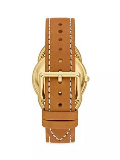 The Tory Burch Miller Goldtone & Leather Analog Watch is the perfect accessory for any fashion-focused Instagram feed. Featuring a sleek goldtone case, leather strap and vibrant cream dial accented by Tory Burch's iconic cursive logo, this watch brings timeless style and luxury to any outfit. As durable as it is designer, it's water resistant and carries the esteemed Tory Burch brand's quality craftsmanship and 2-year warranty. Capture every Instagrammable moment in chic simplicity with the Mill Everyday Gold Leather Watch Band, Gold Leather Strap Watch Band For Everyday, Everyday Gold Watch Band With Leather Strap, Modern Gold Leather Watch Accessories, Gold Watch Band With Leather Strap For Everyday, Modern Gold Watch With Leather Strap, Timeless Yellow Gold Leather Watch, Yellow Gold Leather Watch With Round Dial, Gold Leather Watch With Round Dial