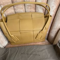 Caramel Color. Medium. Literally Never Used. In Original Box With Bag, Verification Code Available Yellow Bags With Intrecciato Weave For Everyday Use, Gold Rectangular Bag With Intrecciato Weave, Luxury Caramel Top Handle Shoulder Bag, Luxury Caramel Top Handle Bag, Luxury Brown Bag With Intrecciato Weave, Luxury Beige Shoulder Bag With Intrecciato Weave, Luxury Brown Bags With Intrecciato Weave, Luxury Camel Shoulder Bag With Double Handle, Designer Beige Bags With Intrecciato Weave