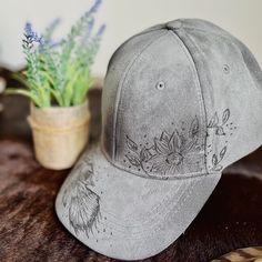 A one-of-a-kind hat, with a unique design hand-burned by our talented artist. Embracing the art of pyrography, this baseball cap is a must-have accessory for any cowboy or cowgirl. Includes an adjustable back strap. We are happy to take custom orders. Please reach out with the design you are looking for!                                                                                          Bundle and save! Do you have a friend or family member who also wants an awesome unique hat? Do you have Hat Burning Designs, Hat Burning, Custom Baseball Hats, Hand Burn, Tiny Clothes, Painted Hats, Unique Hats, Hat Patches, Western Design