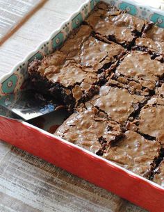 a pan filled with brownies sitting on top of a table