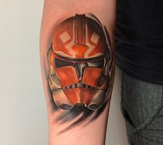 a man's arm with a star wars tattoo on it, including a helmet