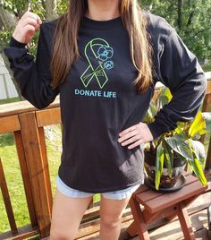 "Our beautiful embroidered green and blue Donate Life with flowers sweatshirt is super soft and comfy. What a great way to bring awareness in our day-to-day existence! These sweatshirts make incredible gifts for family, companions, colleagues or friend. It's also perfect for a loved one going thru challenging times. PRODUCT DETAILS: 50% Cotton, 50% Polyester, Pre-shrunk, Anti-pilling & Classic Unisex Crewneck Fit. Image measures 7 1/2\"x 5 1/2\". SIZE CHART: See the size chart in the listing's p Casual Long Sleeve T-shirt As Gift, Organ Donation Awareness, Donate Life, Organ Donation, Challenging Times, Green And Blue, Gifts For Family, Sweat Shirt, Gender Neutral