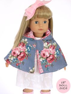 the doll is wearing a blue jacket with pink flowers on it