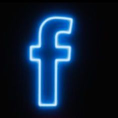 the facebook logo is glowing blue in the dark