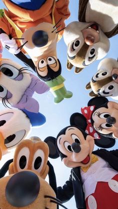 many mickey mouses are standing together in a circle with their heads tilted to the side