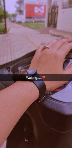 a woman's hand on the steering wheel of a car with an i love waiting message