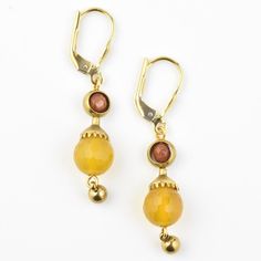 Earrings measure about 1.75" long Brass components Faceted yellow jade and goldstone beads 22k vermeil lever back ear wires About Joli Jewelry Joli Jewelry was started by Jody Lyons in 1984. Inspired by her love of the styles of the 1920's-1960's and her childhood fascination with her mother's and grandmother's jewelry boxes, she began designing pieces for herself while still in college. She was soon discovered by local shop owners in the West Village of Manhattan and began creating her jewelry line. Years later she pursued her interest in psychology in graduate school at Columbia University but was compelled to return to jewelry design. Today her jewelry is sold in boutiques, specialty stores and museum shops around the US, Japan, Hong Kong, the UK and Europe. Goldmakers Jewelry Mission S Gold Jewelry With French Hook And Round Beads, Vintage Gold Earrings With Lever Back, Adjustable Gold Lever Back Earrings, Yellow Dangle Earrings With Lever Back, Amber Dangle Earrings With Lever Back, Amber Dangle Earrings With Lever Back Ear Wires, Gold Brass Jewelry With Lever Back, Adjustable Gold Jewelry With Lever Back, Ring Icon