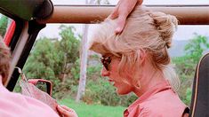 a woman sitting in a vehicle looking at a map