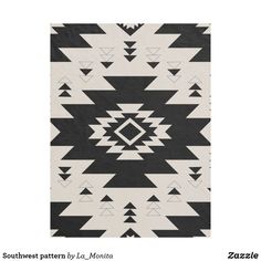 a black and white rug with triangles on the front, and an image of a diamond in