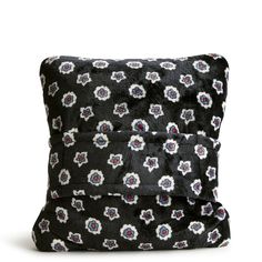 a black and white pillow with flowers on it