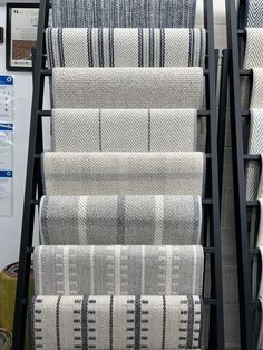 the carpet store has several rows of rugs on display