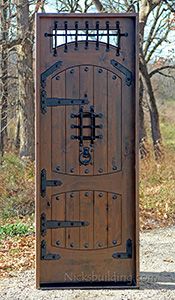 an old wooden door in front of some trees