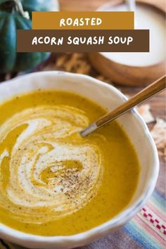 a bowl of roasted acorn squash soup with a spoon in it and text overlay that reads, roasted acorn squash soup cozy comforting delicious