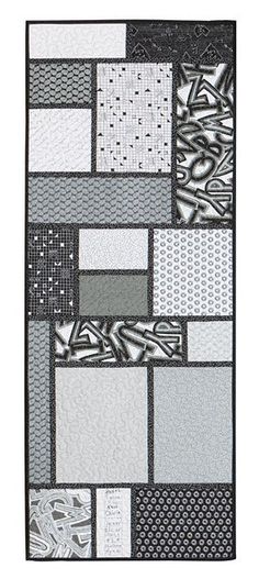 a black and white patchwork quilt with many different patterns on the front, back and sides