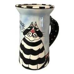 a black and white striped mug with a cat on it