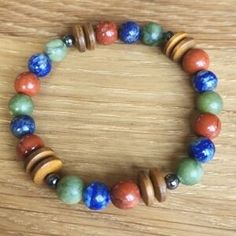 a bracelet made out of wooden beads and multicolored marbles on a table