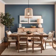 a dining room with blue walls and wooden furniture in the center, along with a rug on the floor