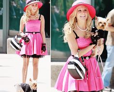 a woman in a pink dress and hat holding a small dog