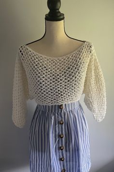 a white and blue striped dress on a mannequin headdress with buttons