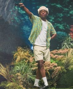 a man standing on top of a lush green field