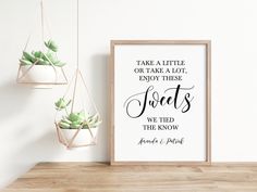 a couple's wedding announcement with succulents hanging on the wall next to a